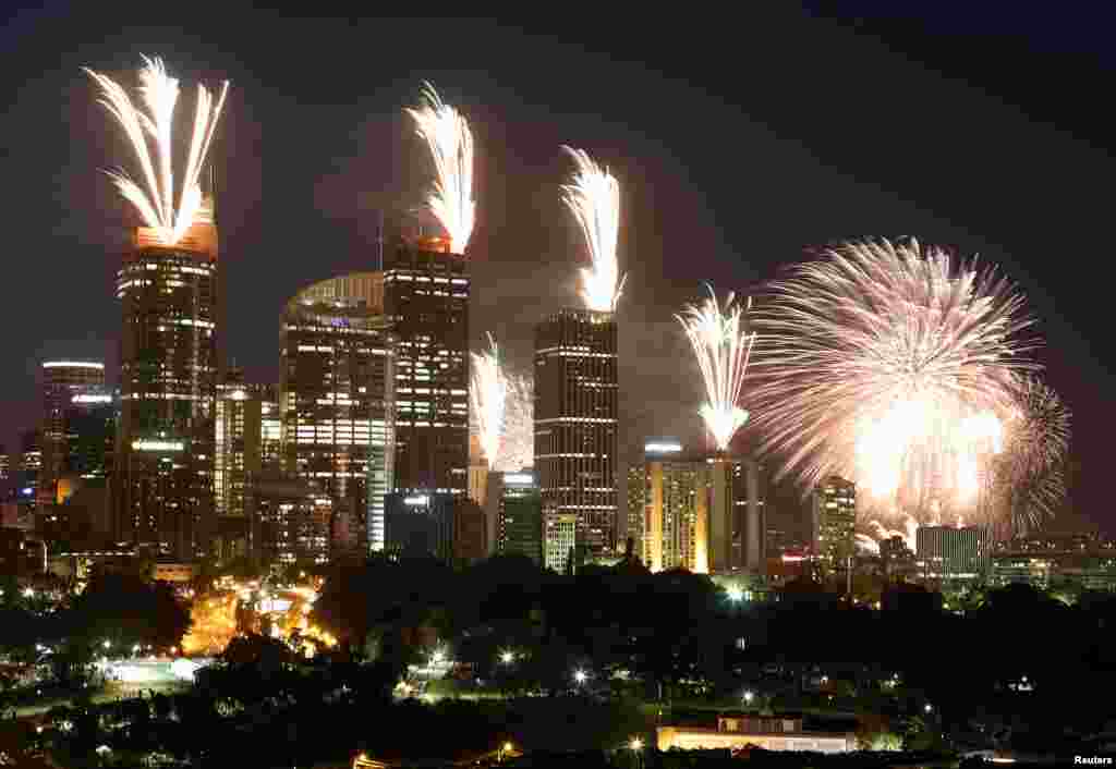 Fireworks explode on the rooftops of buildings during a show prior to the new year celebrations in Sydney, Australia, December 31, 2012.