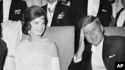 FILE - President John F. Kennedy and first lady Jacqueline Kennedy are seated as they attend one of five inaugural balls in Washington, D.C., Jan. 20, 1961.