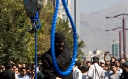 FILE - An Iranian policeman prepares to execute a death sentence in Tehran, Iran, Aug. 2, 2007.