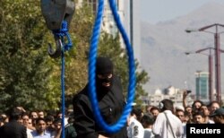 FILE - An Iranian policeman prepares to execute a death sentence in Tehran, Iran, Aug. 2, 2007.