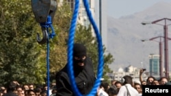 FILE - An Iranian policeman prepares to execute a death sentence in Tehran, Iran, Aug. 2, 2007. Iranian authorities executed five people over "armed drug smuggling" on May 15, 2023.