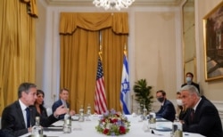 FILE - U.S. Secretary of State Antony Blinken meets with Israeli Foreign Minister Yair Lapid in Rome, Italy, June 27, 2021.