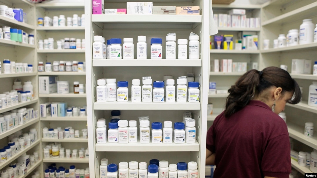 FILE - A pharmacy employee looks for medication as she works to fill a prescription while working at a drugstore in New York. IMS Health predicts global spending will increase by about 30 percent cumulatively from about $1 trillion now to about $1.3 trillion in 2020, driven by expensive new drugs, price hikes, aging populations and increased generic drug use in developing countries.
