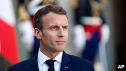 France's President Emmanuel Macron listens to Croatia's Prime Minister Andrej Plenkovic during a speech, at the Elysee Palace, in Paris, Oct. 16, 2018.