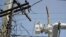 In this Oct. 19, 2017, photo, a brigade from the Electric Power Authority repairs distribution lines damaged by Hurricane Maria in the Cantera community of San Juan, Puerto Rico.