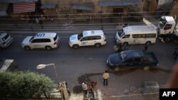 Vehicles of a UN and SARC aid convoy, with food, nutrition, health and other emergency items, enter the rebel-held town of Douma, east of the Syrian capital Damascus, June 10, 2016.