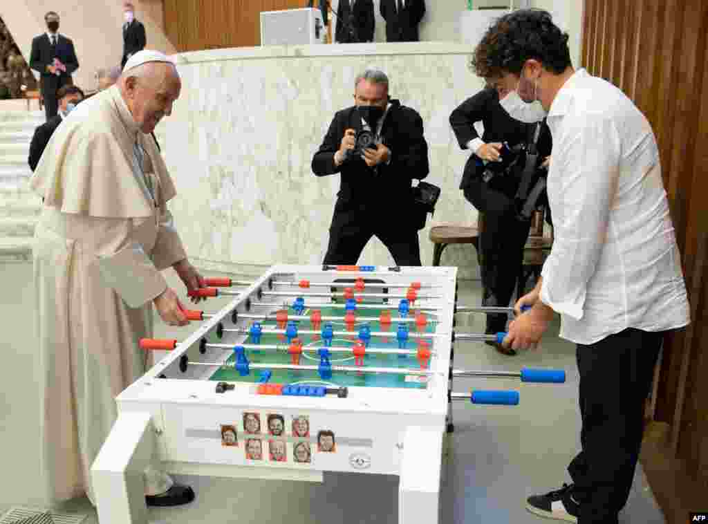 This handout phot released by the Vatican press office, Vatican Media shows Pope Francis playing football table against Natale Tonini of the Tuscany table football amateur association at The Vatican.&#160;
