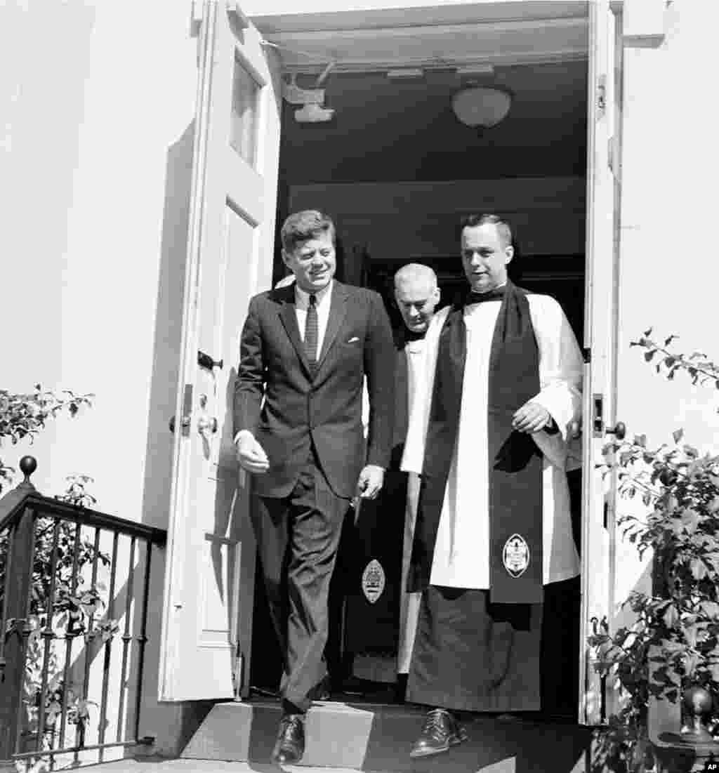 President John F. Kennedy leaves St. John's Episcopal Church in in Washington, D.C., in March 1963, after attending Mass at St. Stephen's Roman Catholic Church. At right is Rev. John C. Harper, new rector of the church, and at rear is Rt. Rev. William F. 