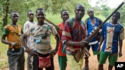 FILE - Fighters from a Christian militia movement known as the "anti-balaka" display their makeshift weaponry in the village of Boubou, halfway between the towns of Bossangoa and Bouca, in the Central African Republic. (AP Photo/Florence Richard)