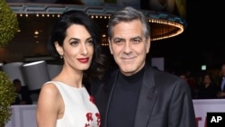 FILE - Amal and George Clooney are pictured in Los Angeles, Feb. 1, 2016. They are donating funds to and will participate in the "March for Our Lives" rally in Washington on March 24, 2018.