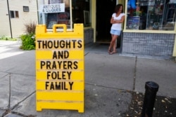 FILE - A sign outside a shop remembers James Foley in his hometown of Rochester, N.H., Aug. 20, 2014.