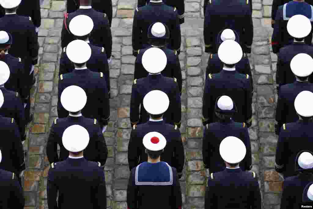 French Navy sailors attend a ceremony in the courtyard of the Invalides in Paris.