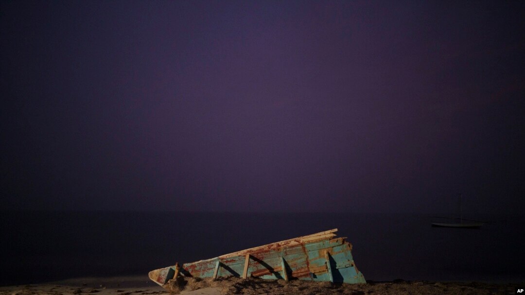 Foto ilustrasi yang menunjukkan bangkai kapal nelayan yang digunakan oleh para migran untuk mencapai Kepulauan Canary di Spanyol, tergeletak di sebuah pantai di dekat Nouadhibou, Mauritania, pada 2 Desember 2021. (Foto: AP/Felipe Dana)