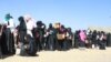 FILE - Ethiopian women wait in a line at custom area as they arrive at Bole International Airport in Ethiopia’s capital, Addis Ababa, Dec. 18, 2013, after they were deported from Saudi Arabia. 