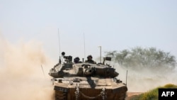 FILE—This picture taken from Israel's southern border with the Gaza Strip shows an Israeli tank rolling along the border with the Palestinian territory on April 16, 2024, amid the ongoing conflict between Israel and the militant group Hamas. 