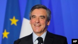 French conservative presidential candidate Francois Fillon smiles during a speech on defense policy, March 31, 2017 in Paris. 