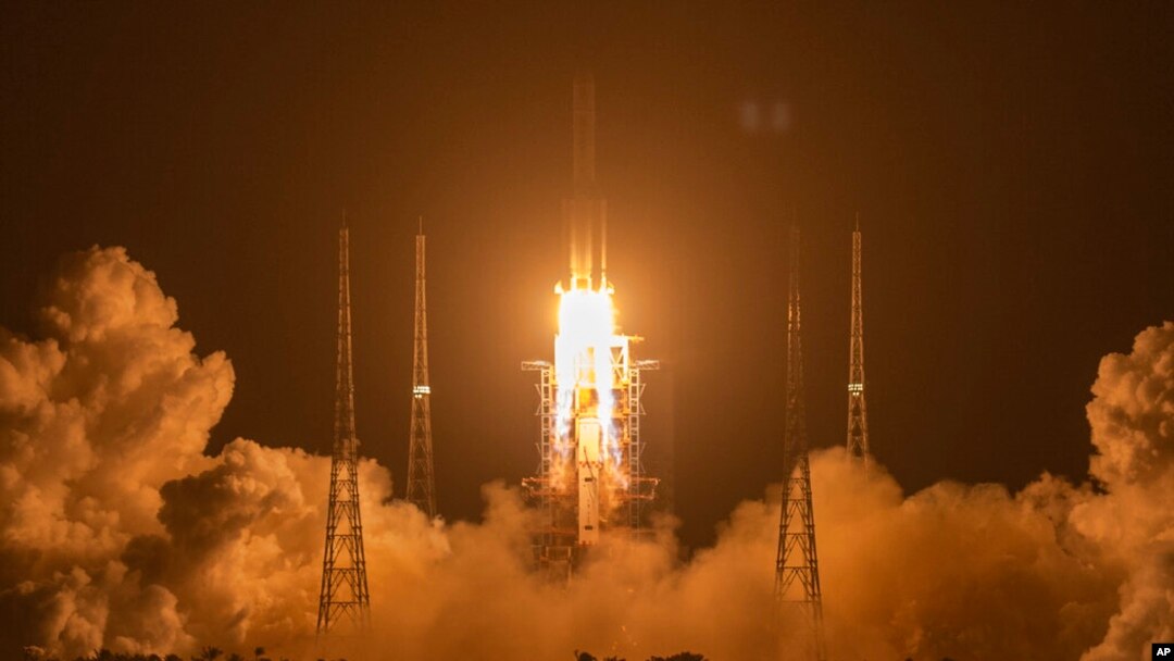 FILE - In this Nov. 24, 2020, photo, a Long March-5 rocket carrying the Chang'e 5 lunar mission lifts off at the Wenchang Space Launch Center in Wenchang in southern China's Hainan Province.