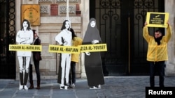 FILE - Demonstrators from Amnesty International stage the protest on International Women's day to urge Saudi authorities to release jailed women's rights activists Loujain al-Hathloul, Eman al-Nafjan and Aziza al-Yousef outside the Saudi Arabian Embassy i
