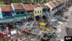 This picture shows damaged buildings and debris on a street after Super Typhoon Yagi hit Ha Long, in Quang Ninh province, on Sept. 8, 2024.