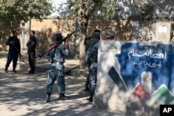 Afghan police arrive at the site of an attack at Kabul University in Kabul, Afghanistan, Nov. 2, 2020. Gunfire erupted at the university in the Afghan capital early Monday and police have surrounded the sprawling campus, authorities said.