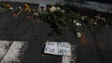 Flowers lie at a makeshift memorial at the scene of where a car plowed into counter-protesters in Charlottesville, Virginia, Aug. 13, 2017.