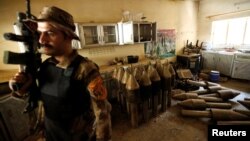 A member of the Iraqi counterterrorism forces stands by an Islamic State militants weapons factory in Falluja, Iraq, June 23, 2016.