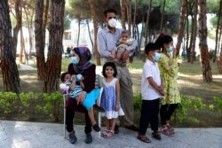 An Afghan family gathers at a resort that is accommodating Afghan refugees in Golem, Albania, Aug. 27, 2021.