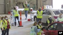 This 2020 photo provided by Carlton County shows their drive-thru flu clinic in Carlton, Minn. (Jared Hovi/Carlton County GIS via AP)