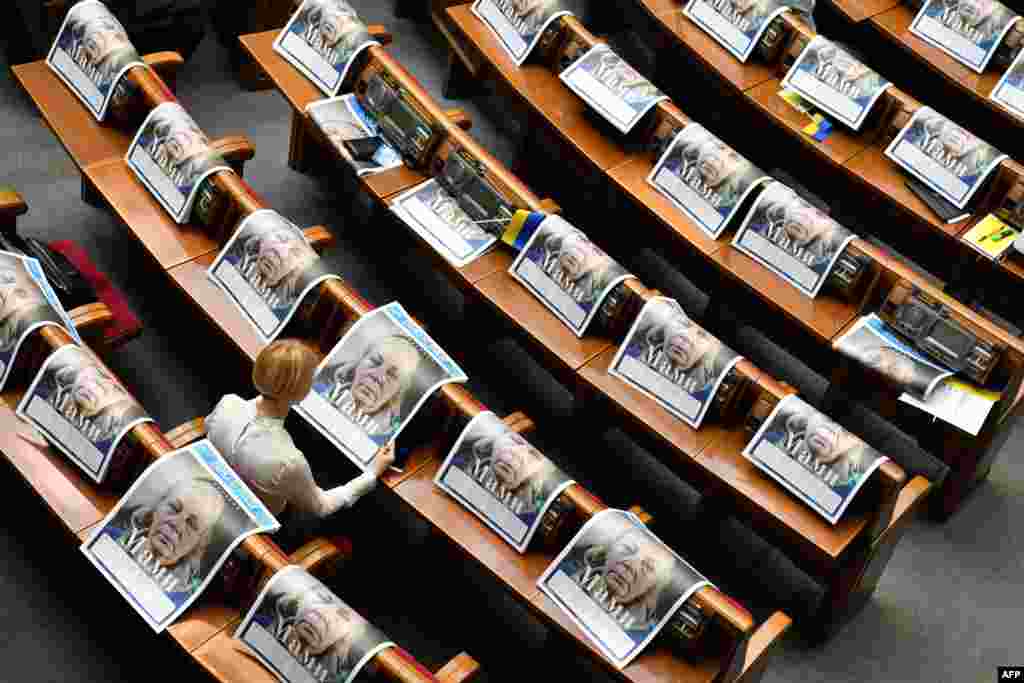 A deputy reads a special edition of the newspaper &quot;Dzerkalo Tyzhnia&quot; dedicated to mothers of Ukrainian servicemen who died in the battle with Russia-backed separatists, before the solemn opening and first sitting of the new parliament in Kyiv.