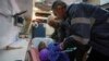 An Egyptian medic assists a young Palestinian patient evacuated from Gaza through the Rafah crossing as the child arrives at al-Arish General Hospital in Egypt's north eastern Sinai province, Feb. 1, 2025.