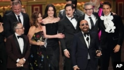 Adam Greenfield, left, and David Adjmi, center, and members of the company of "Stereophonic" accept the award for best play during the 77th Tony Awards on Sunday, June 16, 2024, in New York.