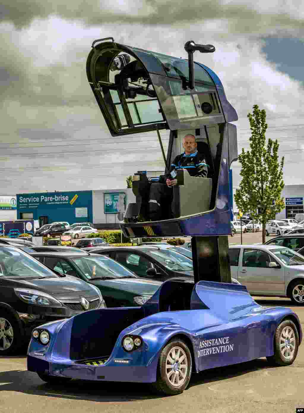 A man drives the &quot;Iris viseo&quot;, an electric surveillance vehicle with a telescopic cockpit designed and manufactured in France at the car park of a shopping center in Noyelles-Godault.