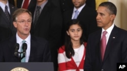 President Barack Obama and sixth grade student Keiry Herrera of Graham Road Elementary School in Fairfax, Va., listen as Tennessee Gov. Bill Haslam, left, speaks during an event for No Child Left Behind Reform,in the East Room at the White House in Washin