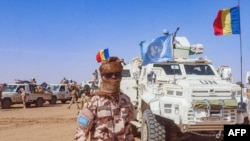FILE - A Chadian soldier with the United Nations Multidimensional Integrated Stabilization Mission in Mali (MINUSMA) stands in front of a convoy outside the city of Gao in Mali on Oct. 25, 2023.
