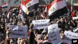 Egyptian women protesters shout as they raise slogans demanding the head of the military ruling council to step out at Tahrir Square in Cairo, Egypt, December 23, 2011.