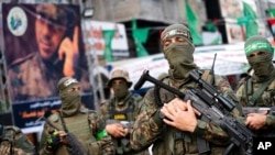 Hamas militants parade through the streets for Bassem Issa, a top commander killed by Israeli Defense Forces military actions prior to a cease-fire reached after 11 days of conflict between Gaza's Hamas rulers and Israel, in Gaza City, May 22, 2021.