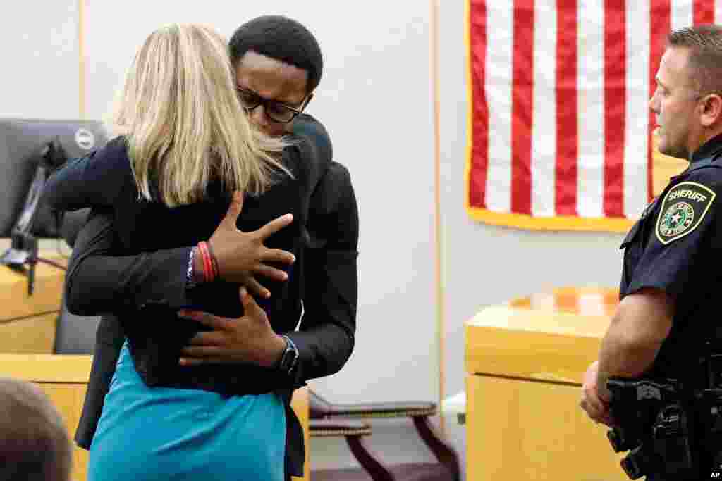 Botham Jean&#39;s brother, Brandt Jean, hugs convicted murderer and former police officer Amber Guyger after she was sentenced to 10 years in prison, Oct. 2, 2019, in Dallas, Texas. Guyger shot and killed her neighbor Botham Jean in his apartment last year.