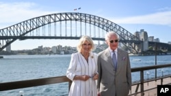 Britain's King Charles III, right, and Queen Camilla pose for pictures in front of the Sydney Harbour Bridge on Oct. 22, 2024 in Sydney, Australia. 