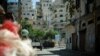 Lebanese army armored vehicles idle on Syria Street between the Jebel Mohsen and Bab Tabbaneh neighborhoods of Tripoli, Lebanon, August 23, 2012. (VOA/Jeff Neumann)