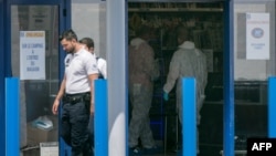 Forensic police officers work at the supermarket where two people were injured when a woman shouting "Allah akbar" (God is greatest) attacked two people with a boxcutter on June 17, 2018 in La Seyne-sur-Mer, southern France. 