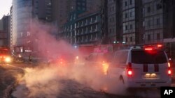 This image provided by Mongolia National Emergency Management Agency, shows a building, right, damaged by an explosion in Ulaanbaatar, Mongolia Jan. 24, 2024. A truck carrying 60 tons of liquefied natural gas and a car collided at an intersection in the Mongolian capital.