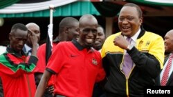 Le président kényan Uhuru Kenyatta, à droite, parle au capitaine de l'équipe olympique Wesley Korir à Nairobi, Kenya, le 22 juillet 2016.