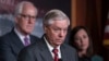 U.S. Senator Lindsey Graham of South Carolina, flanked by Senator John Cornyn of Texas, left, and Senator Katie Britt of Alabama, speaks to reporters as they criticize President Joe Biden's policies on the U.S.-Mexico border, at the Capitol in Washington on Dec. 7, 2023.