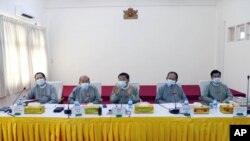 Members of the Union Election Commission wear face masks during a press conference, announcing that general elections in Myanmar will proceed as planned in November despite coronavirus concerns, in Naypyitaw, Myanmar, June 4, 2020. © 2020 AP