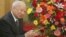 Cambodian King Norodom Sihanouk stands beside flowers given by the Chinese government during a meeting with Chinese State Councilor Dai Bingguo (not seen) in Beijing, October 30, 2006.