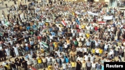 Demonstrators protesting against Syria's President Bashar al-Assad march through the streets after Friday prayers in Homs October 7, 2011. Syrian forces killed at least eight people when they opened fire to disperse protests against President Bashar al-A