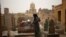 A woman who lives in the Cairo Necropolis cleans a tomb, outside her home in Cairo, Egypt, October 23, 2015. In the sprawling Cairo Necropolis, known as the City of the Dead, life and death are side by side.