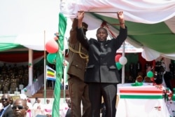 FILE - Burundi's President Evariste Ndayishimiye gestures to the crowd after his inauguration in Gitega, Burundi, June 18, 2020.