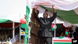FILE - Burundi's President Evariste Ndayishimiye gestures to the crowd after his inauguration in Gitega, Burundi, June 18, 2020.