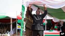 FILE - Burundi's President Evariste Ndayishimiye gestures to the crowd after his inauguration in Gitega, Burundi, June 18, 2020. 